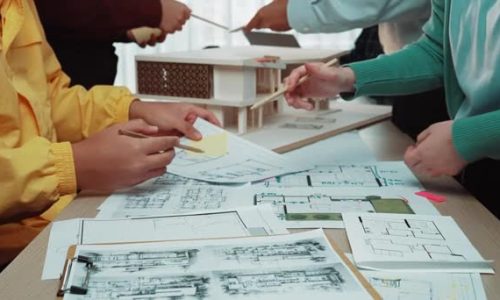 stock-video-dynamic-scene-professionals-actively-collaborating-architectural-plans-technical-drawings-modern